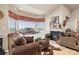 Cozy living room with plush seating, a fireplace, and large windows with scenic views at 22990 County Road 30, Hudson, CO 80642
