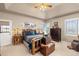 A spacious bedroom features vaulted ceilings, a rustic wooden bed frame, and plenty of natural light at 22990 County Road 30, Hudson, CO 80642