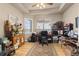 Bright office features hardwood floors, a large desk, and a window with outside views at 22990 County Road 30, Hudson, CO 80642