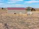 Aerial view of a property with a barn, fencing, and pasture, ideal for equestrian pursuits at 22990 County Road 30, Hudson, CO 80642