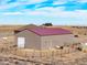 Property with a large outbuilding, fencing, and a view of a residence at 22990 County Road 30, Hudson, CO 80642