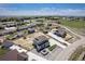 Aerial view of a neighborhood showcasing a gray home with landscaped front yard, long driveway, and neighborhood surroundings at 4532 Dewey Ln, Brighton, CO 80603