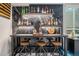 Stylish basement bar featuring a sleek countertop, open shelving, and ample storage for beverages at 4532 Dewey Ln, Brighton, CO 80603