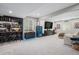 Finished basement with a sleek bar area, custom lighting, and a large TV for entertainment at 4532 Dewey Ln, Brighton, CO 80603