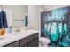 Cozy bathroom showcasing a Minecraft-themed shower curtain and vanity with a modern faucet at 4532 Dewey Ln, Brighton, CO 80603
