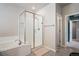 Bright bathroom with a glass-enclosed shower and separate soaking tub at 4532 Dewey Ln, Brighton, CO 80603