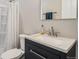 Bathroom featuring a modern vanity, updated fixtures, and a shower with patterned curtains at 4532 Dewey Ln, Brighton, CO 80603
