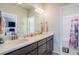 Bright bathroom featuring a double vanity with solid surface countertops at 4532 Dewey Ln, Brighton, CO 80603