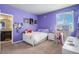 The purple ' bedroom features a vanity with lights, closet, and an ensuite bath at 4532 Dewey Ln, Brighton, CO 80603