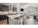 Open-concept kitchen with island seating, flowing into a comfortable living space at 4532 Dewey Ln, Brighton, CO 80603