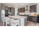 Modern kitchen featuring a large island with seating and stylish gray cabinets at 4532 Dewey Ln, Brighton, CO 80603