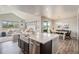 Bright kitchen showcasing stainless steel appliances and a large island, with dining area at 4532 Dewey Ln, Brighton, CO 80603