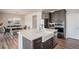 Modern kitchen island with seating, stainless steel appliances, and adjacent dining area at 4532 Dewey Ln, Brighton, CO 80603
