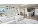 Open concept living room with large sectional sofa leading into kitchen at 4532 Dewey Ln, Brighton, CO 80603