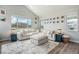 Bright living room with vaulted ceilings, featuring a comfortable sectional sofa and large windows at 4532 Dewey Ln, Brighton, CO 80603