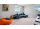 Comfortable loft with sofa, beanbag, and large windows for ample natural light at 4532 Dewey Ln, Brighton, CO 80603