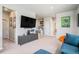 Spacious loft area with TV and staircase in neutral color scheme at 4532 Dewey Ln, Brighton, CO 80603