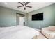 This neutral bedroom has a tv and comfortable chair for a serene retreat at 4532 Dewey Ln, Brighton, CO 80603