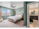 This bright, modern main bedroom features an ensuite bath and neutral tones at 4532 Dewey Ln, Brighton, CO 80603