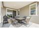 Covered patio featuring comfortable seating, an outdoor grill, and a sliding glass door to the interior at 4532 Dewey Ln, Brighton, CO 80603