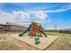 Community playground with multiple slides, climbing structures, and a safe, cushioned ground at 4532 Dewey Ln, Brighton, CO 80603
