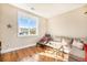 Bright, comfy living room with hardwood floors, a large window, and natural light at 5385 Warrior St, Frederick, CO 80504