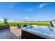 Backyard with patio and a new hot tub, ideal for relaxing and enjoying the surrounding green space at 3047 Deer Creek Ranch Loop, Parker, CO 80138