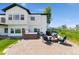 Backyard featuring a patio with fire pit and furniture, hot tub, and a well-maintained lawn at 3047 Deer Creek Ranch Loop, Parker, CO 80138