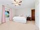 Bright bedroom with plush carpet, ceiling fan, and large window offering great natural light and outside views at 3047 Deer Creek Ranch Loop, Parker, CO 80138