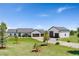 A bright ranch-style home with a large garage, a long driveway, and a well-manicured front lawn at 3047 Deer Creek Ranch Loop, Parker, CO 80138