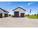 Detached garage with ample parking space, complemented by a well-maintained driveway and an American flag at 3047 Deer Creek Ranch Loop, Parker, CO 80138