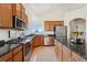 Spacious kitchen featuring stainless steel appliances, granite countertops, and tiled floors at 3047 Deer Creek Ranch Loop, Parker, CO 80138