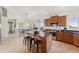 Open-concept kitchen with island, granite countertops, stainless appliances, and eat-in dining at 3047 Deer Creek Ranch Loop, Parker, CO 80138