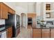 Modern kitchen featuring stainless steel appliances, granite countertops, and wooden cabinets at 3047 Deer Creek Ranch Loop, Parker, CO 80138
