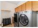 Well-equipped laundry room with modern washer and dryer units and ample storage at 3047 Deer Creek Ranch Loop, Parker, CO 80138