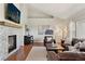 Inviting living room with stone fireplace, grand piano, and hardwood floors offers a relaxing ambiance at 3047 Deer Creek Ranch Loop, Parker, CO 80138