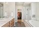 Elegant bathroom featuring a double vanity, large shower, soaking tub and walk-in closet at 3047 Deer Creek Ranch Loop, Parker, CO 80138