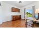 Office space with hardwood floors, built-in cabinets, and a view of the landscaped yard at 3047 Deer Creek Ranch Loop, Parker, CO 80138