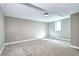 Finished basement area featuring neutral paint, carpet, baseboards, and a single window at 507 S Pontiac Way, Denver, CO 80224