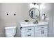 Stylish bathroom featuring a modern vanity with a round mirror and matte black fixtures at 507 S Pontiac Way, Denver, CO 80224