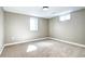 Bright bedroom showcasing carpet floors, two windows providing natural light, and neutral walls at 507 S Pontiac Way, Denver, CO 80224