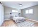 Comfortable bedroom with hardwood floors, neutral walls, and ample natural light from two windows at 507 S Pontiac Way, Denver, CO 80224