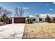 Charming front exterior featuring a modern wood garage door and manicured lawn at 507 S Pontiac Way, Denver, CO 80224