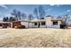 Charming front exterior featuring a modern wood garage door and manicured lawn at 507 S Pontiac Way, Denver, CO 80224