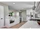 Updated kitchen features white quartz countertops, stainless steel appliances, and modern fixtures at 507 S Pontiac Way, Denver, CO 80224
