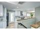 This kitchen has modern appliances, crisp white cabinetry, and an adjacent dining area at 507 S Pontiac Way, Denver, CO 80224