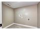 Clean laundry room showcasing tile floors, neutral walls, and connections for laundry machines at 507 S Pontiac Way, Denver, CO 80224