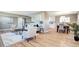 A spacious living area boasts wood floors, ample seating, and a seamless transition to the dining area and kitchen at 507 S Pontiac Way, Denver, CO 80224
