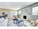 The bright living room showcases wood floors, a stunning fireplace, and neutral colors that complement the decor at 507 S Pontiac Way, Denver, CO 80224