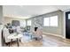 Sunlit living room has wood floors, modern fireplace, and neutral colors, creating a warm and inviting atmosphere at 507 S Pontiac Way, Denver, CO 80224